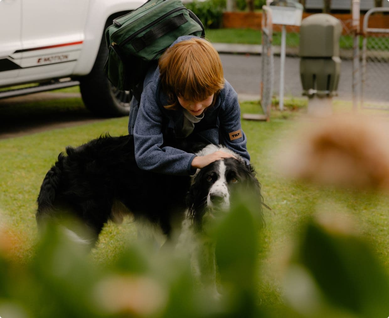 Young boy patting his dog